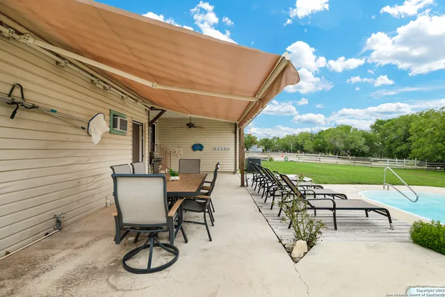 a view of a chairs and table in the patio
