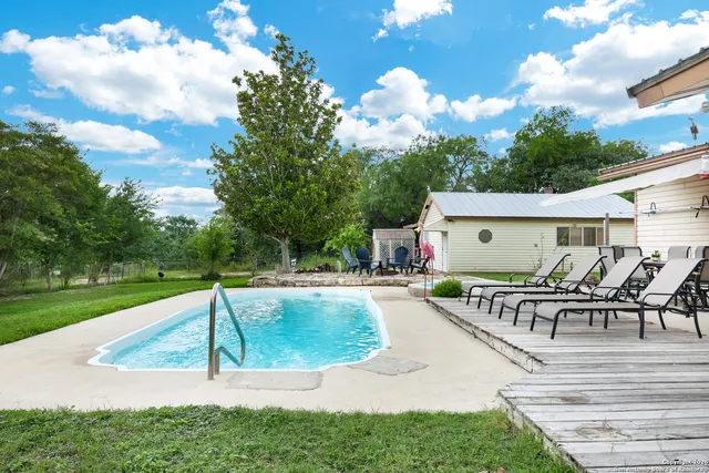 a view of a house with backyard sitting area and garden