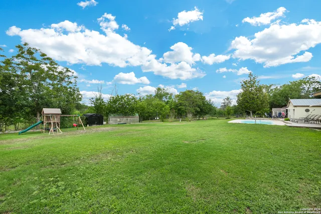 a backyard of a house with table and chairs