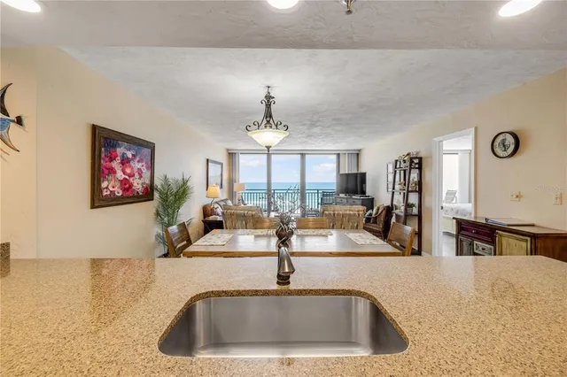 a kitchen with a sink and a large mirror
