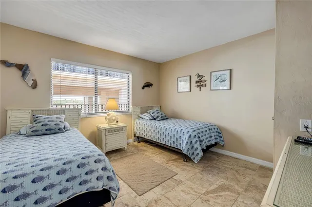 a bedroom with two beds and a couch