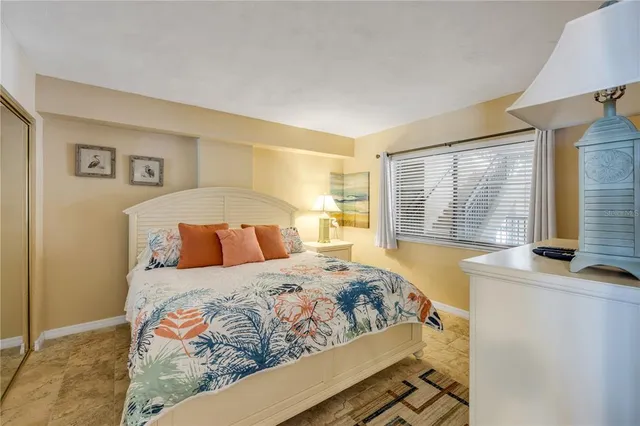 a bedroom with a large bed and a window