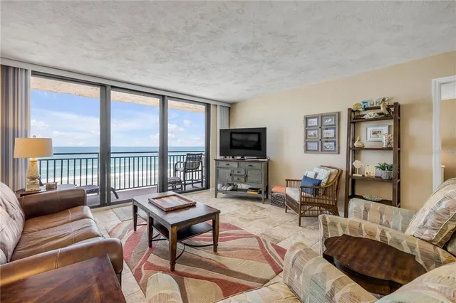 a living room with furniture tv and a large window