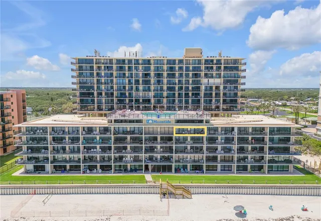 a view of a big yard and a large buildings