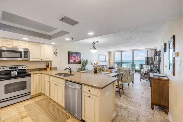a kitchen with lots of counter top space a sink appliances and cabinets