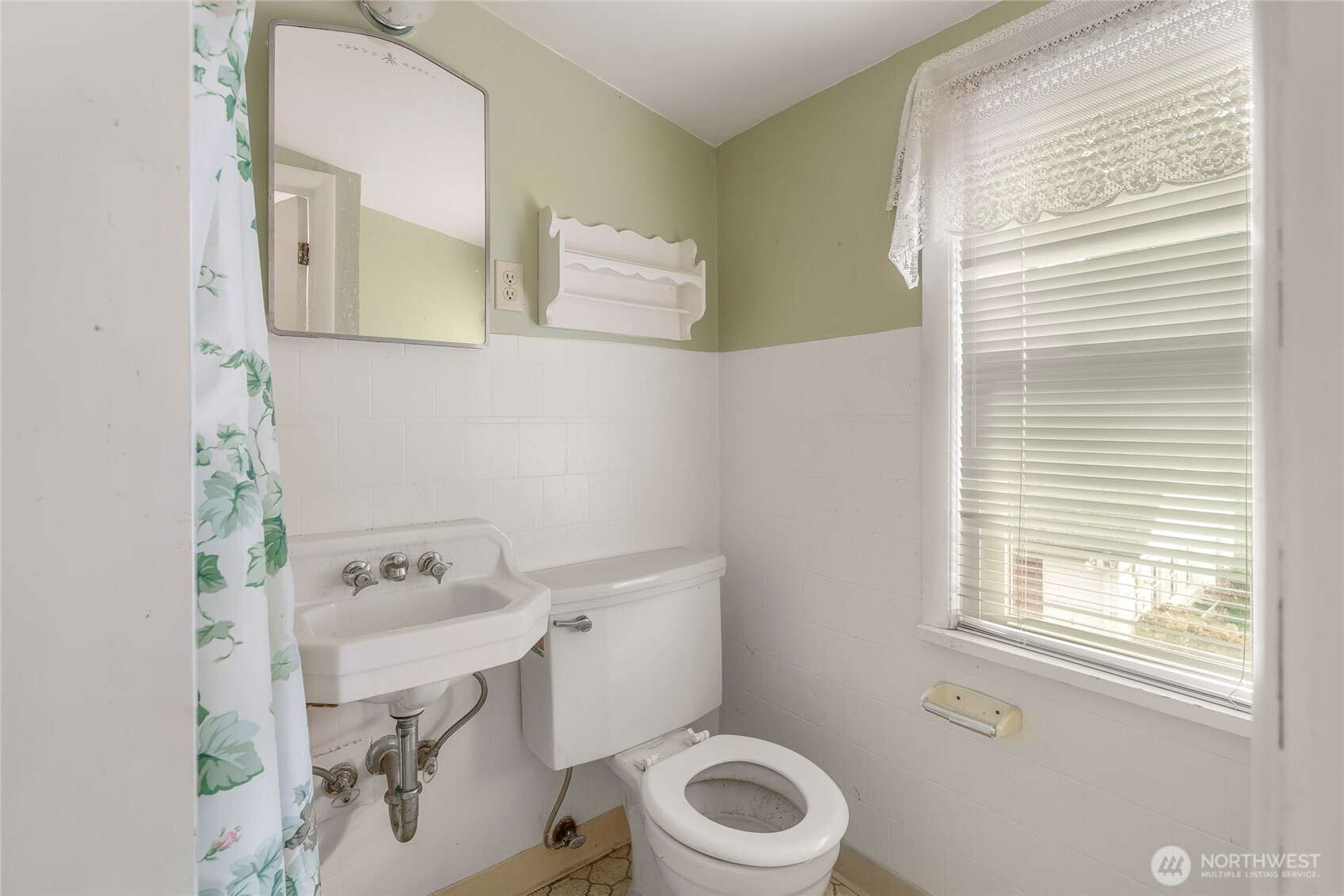 1020 Puget Drive Edmonds, WA 98020 - Photo 12 of 22 a bathroom with a sink a toilet and a mirror