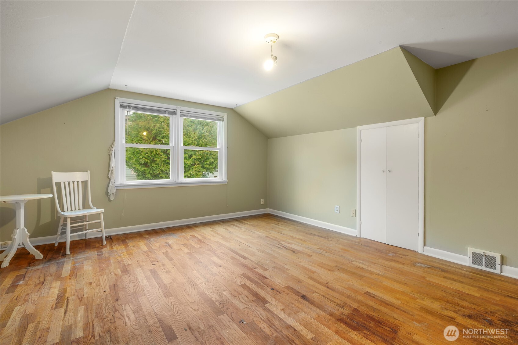 1020 Puget Drive Edmonds, WA 98020 - Photo 13 of 22 a view of an empty room with a window and wooden floor
