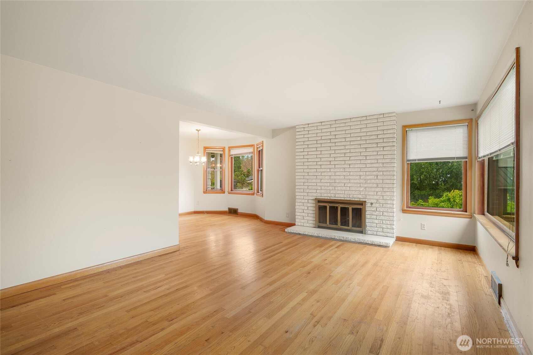 1020 Puget Drive Edmonds, WA 98020 - Photo 4 of 22 wooden floor fireplace and windows in an empty room