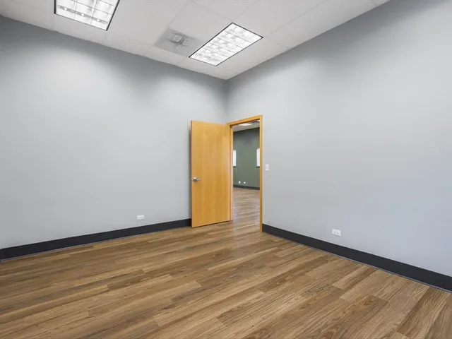 a view of an empty room with glass door