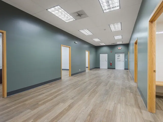 a view of an empty room with glass door