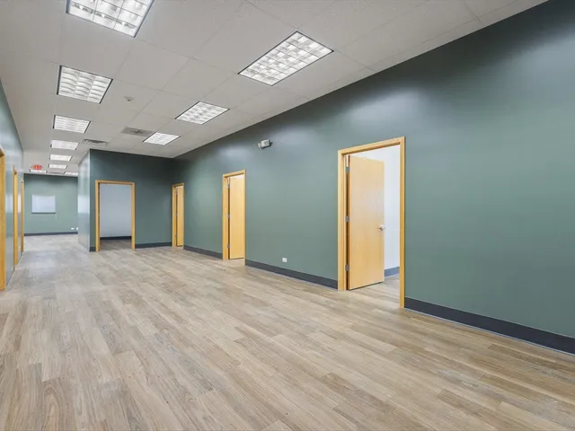 a kitchen with a refrigerator and a stove top oven