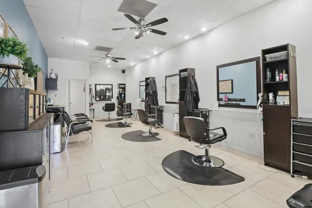 a room with lots of chairs and mirrors