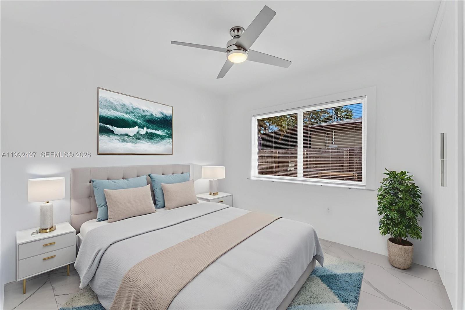 875 East 8th Street Hialeah, FL 33010 - Photo 12 of 36 a bedroom with a bed and a potted plant