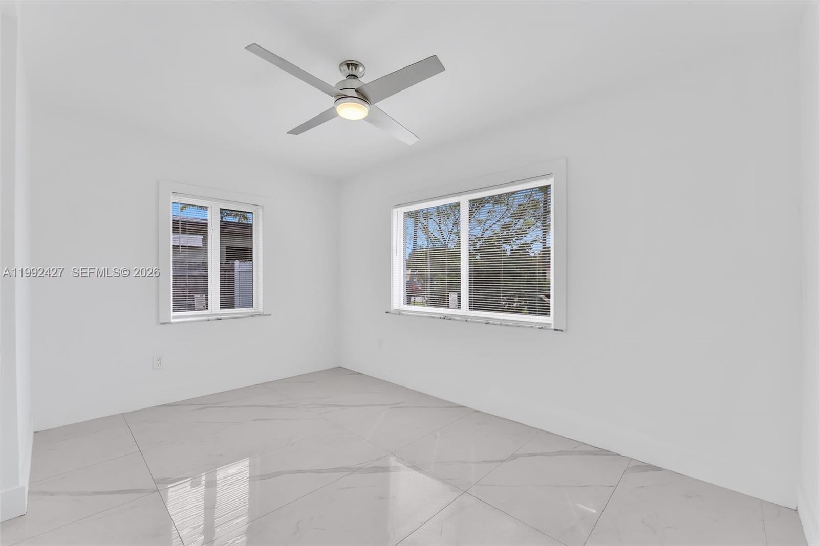 875 East 8th Street Hialeah, FL 33010 - Photo 19 of 36 a view of an empty room with a window