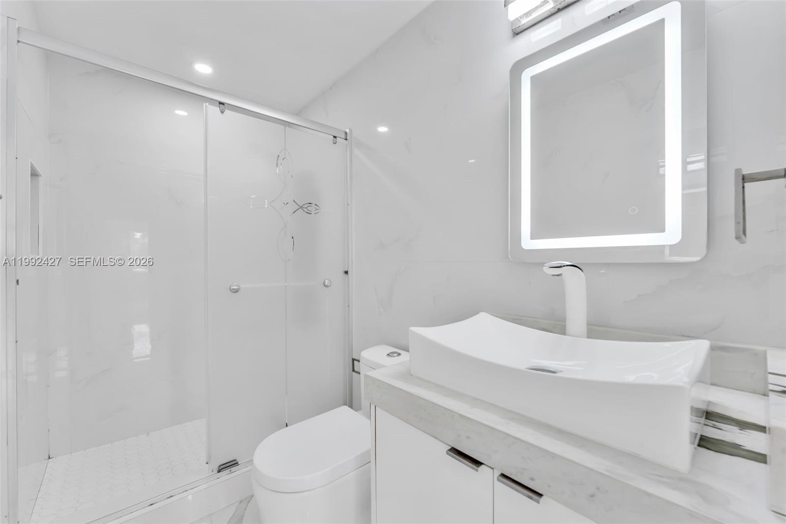 875 East 8th Street Hialeah, FL 33010 - Photo 20 of 36 a bathroom with a sink a toilet and shower