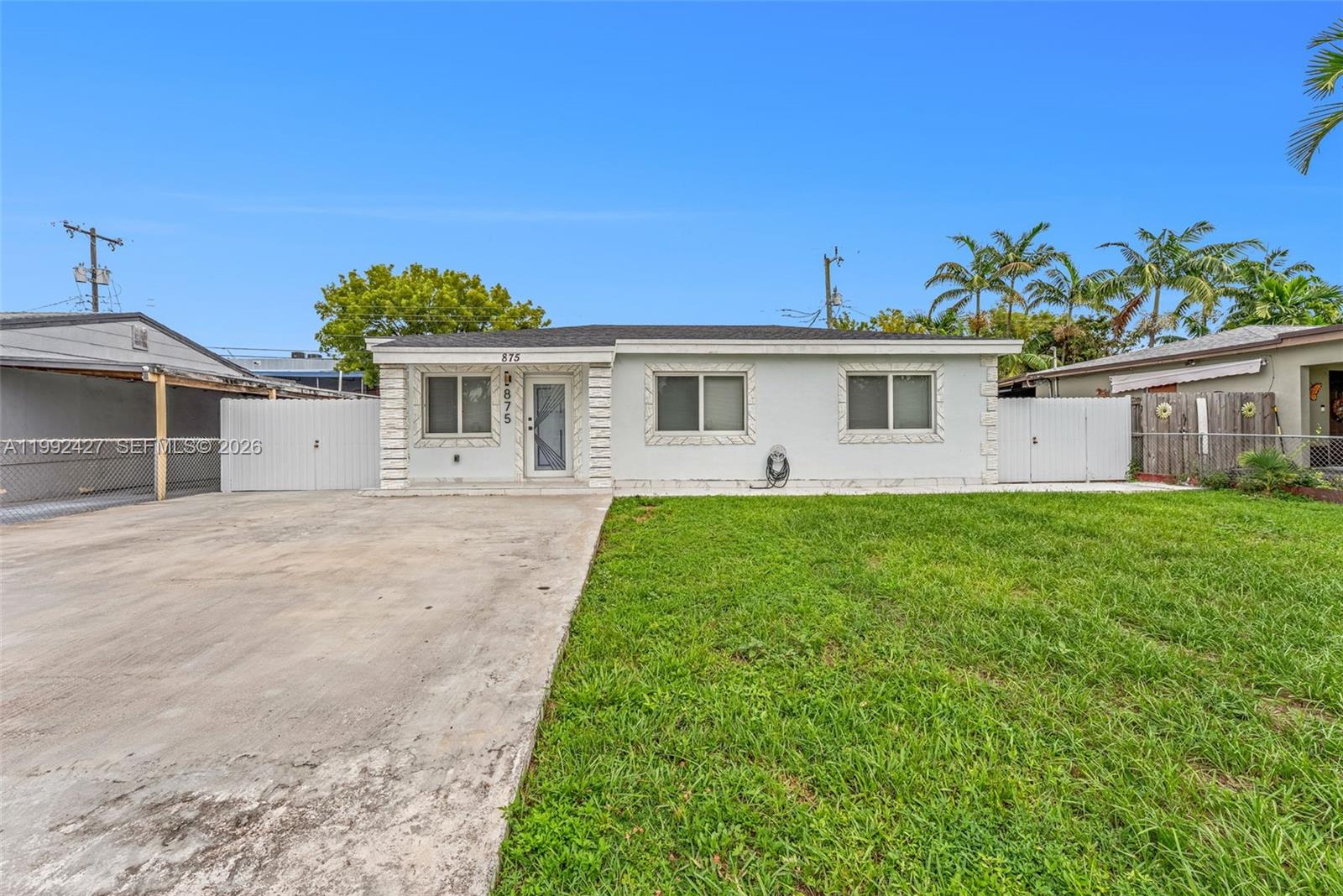 875 East 8th Street Hialeah, FL 33010 - Photo 29 of 36 a front view of a house with a garden