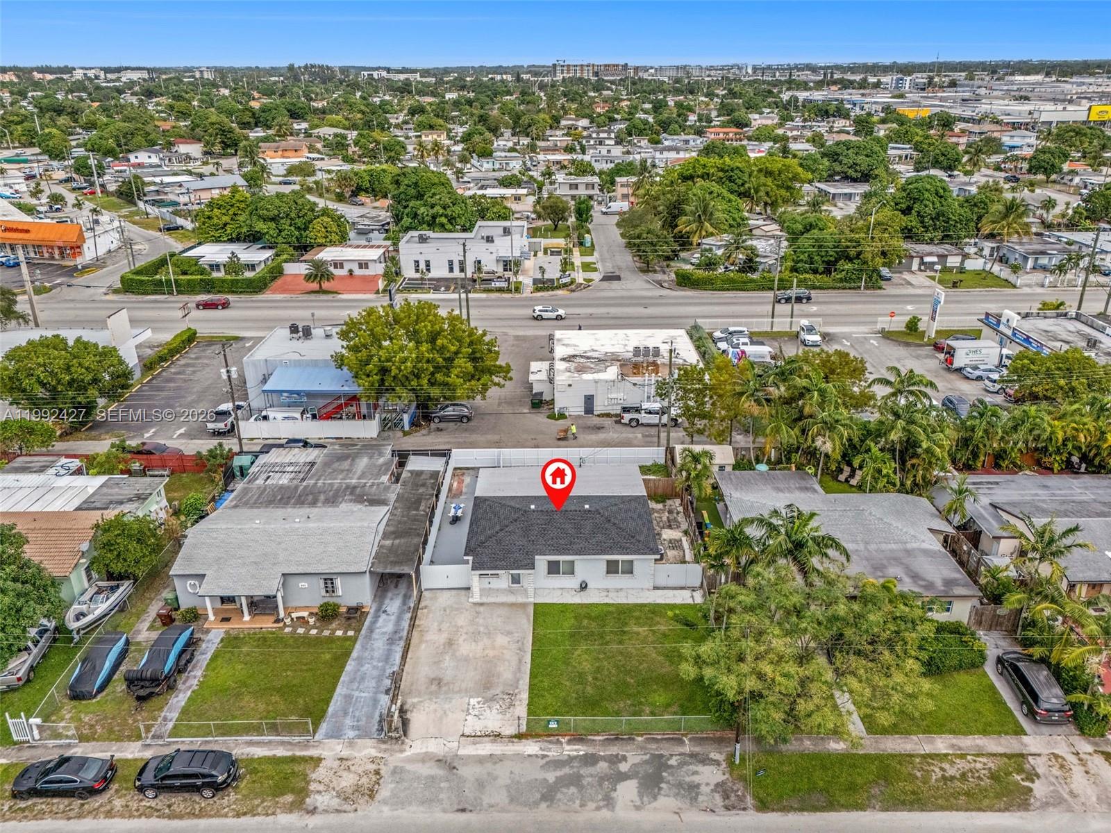 875 East 8th Street Hialeah, FL 33010 - Photo 34 of 36 an aerial view of residential houses with outdoor space and parking