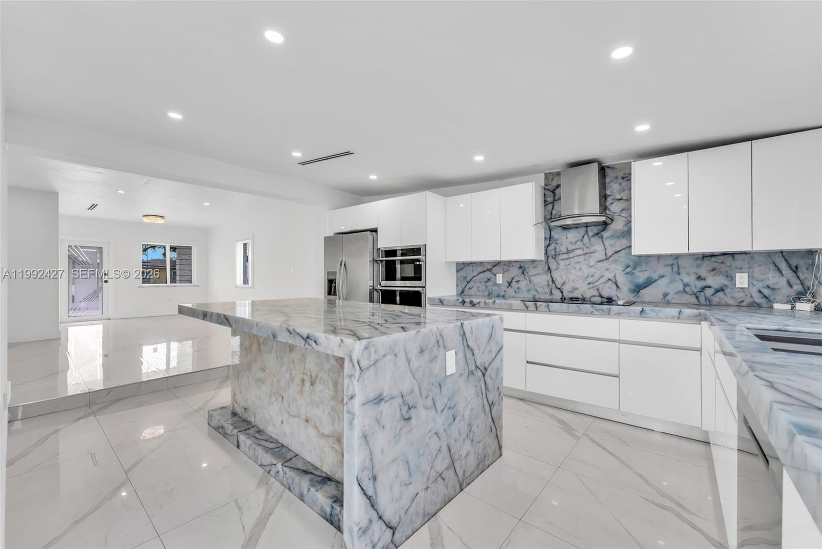 875 East 8th Street Hialeah, FL 33010 - Photo 7 of 36 a kitchen with stainless steel appliances granite countertop a stove a sink and a refrigerator