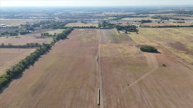 an aerial view of residential houses with outdoor space and ocean view