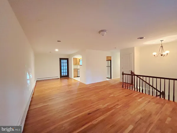 a view of a kitchen with wooden floor and a kitchen