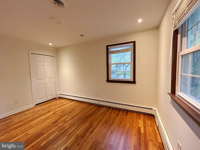 a view of a room with wooden floor and window