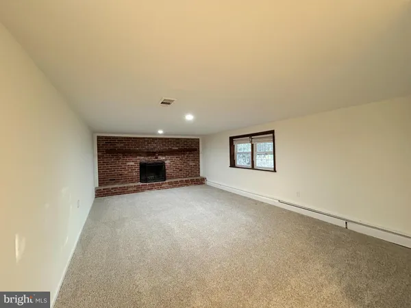 a view of empty room with fireplace