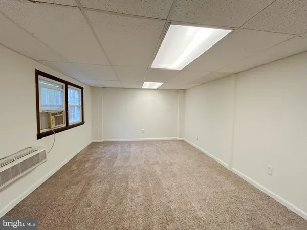 an empty room with a fireplace and painted walls