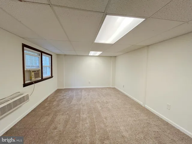 an empty room with a fireplace and painted walls