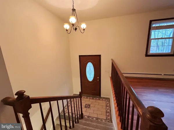 a view of a room with wooden floor and windows