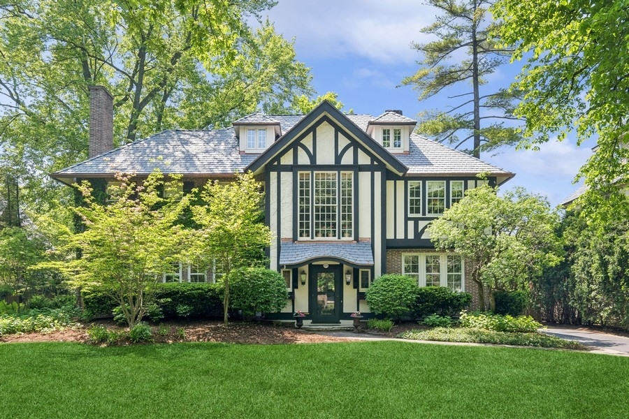 212 Warwick Road Kenilworth, IL 60043 - Photo 1 of 1 a front view of a house with a garden and plants
