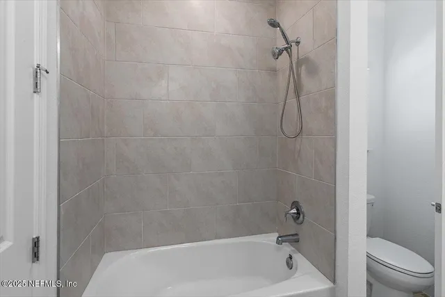 a bathroom with a shower and a toilet