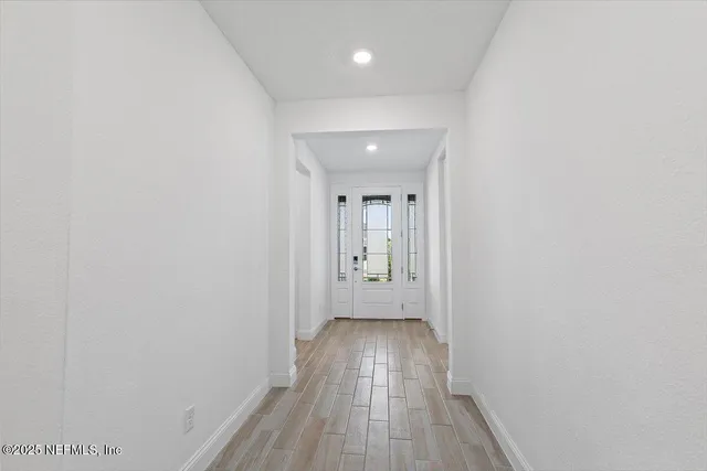 a view of hallway with wooden floor