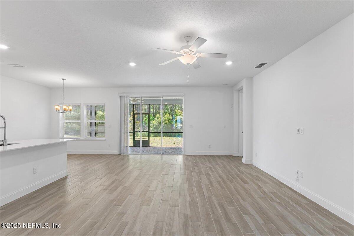 21 Pine Candle Way St. Augustine, FL 32092 - Photo 4 of 35 a view of an empty room with wooden floor and a window
