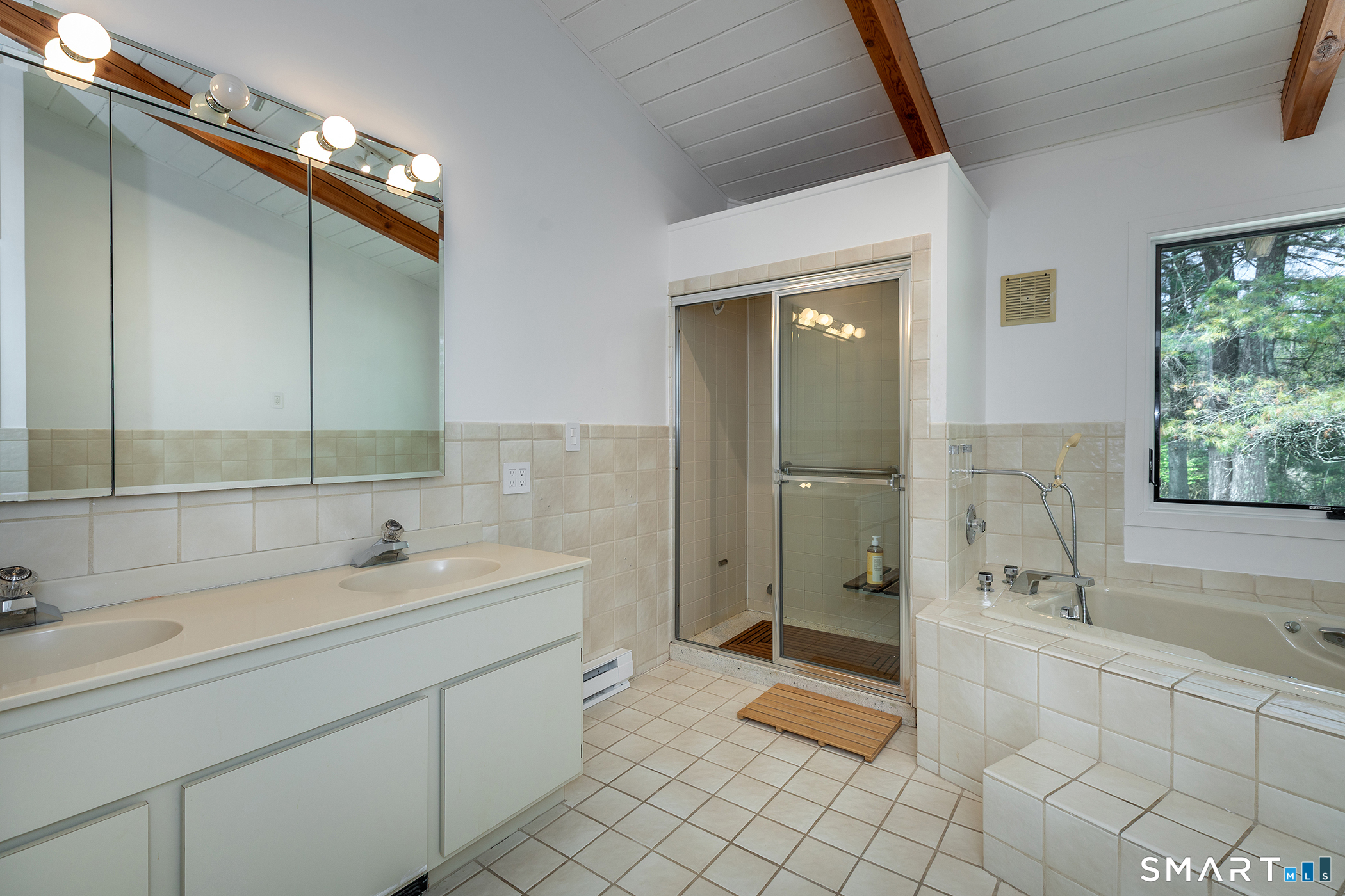 94 Washinee Heights Road Salisbury, CT 06068 - Photo 29 of 38 a spacious bathroom with a shower a sink and a mirror
