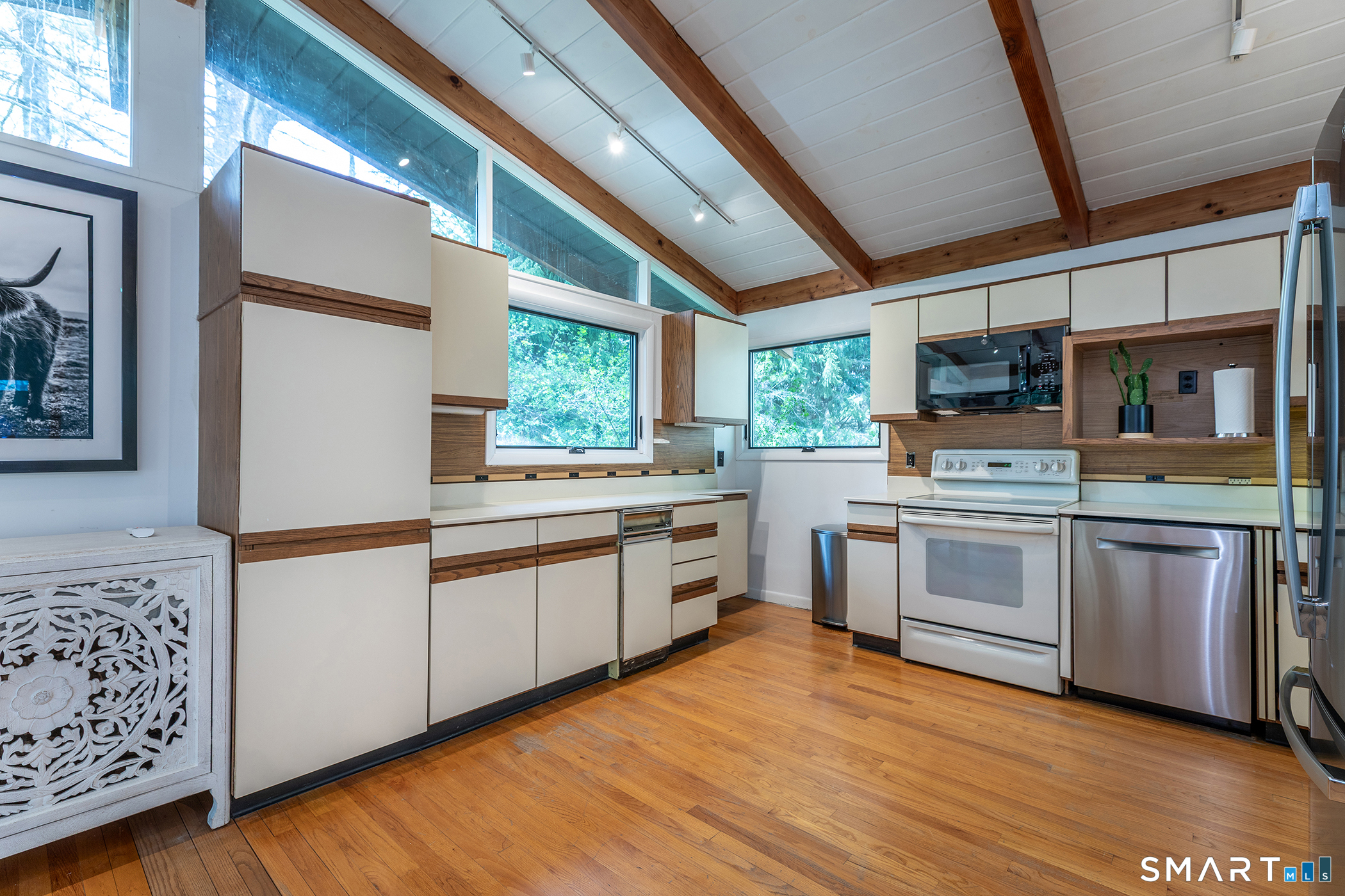 94 Washinee Heights Road Salisbury, CT 06068 - Photo 35 of 38 a kitchen with stainless steel appliances white cabinets a wooden floor and a sink