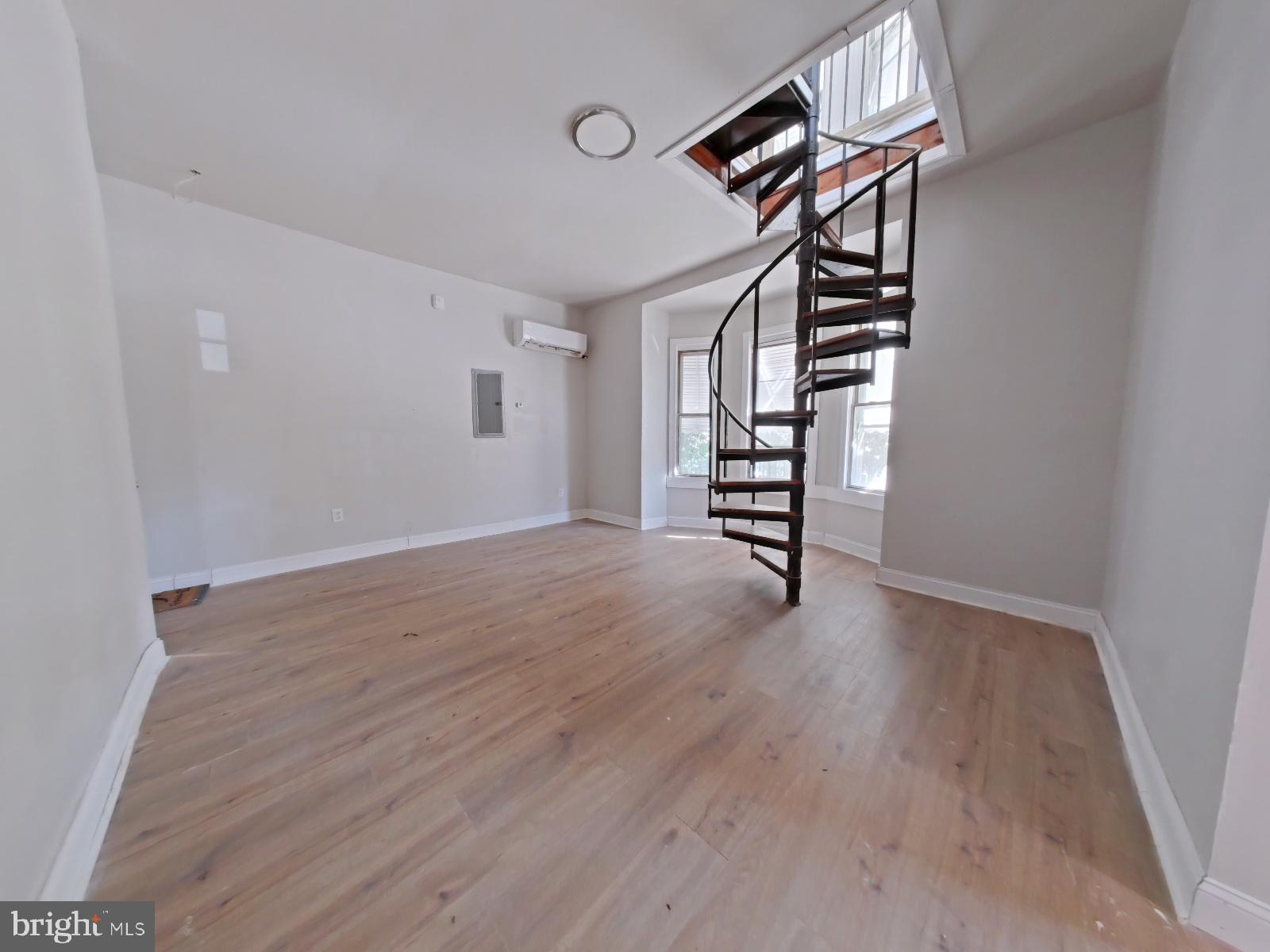 5331 Wayne Avenue Philadelphia, PA 19144 - Photo 14 of 53 a view of an empty room with stairs and wooden floor