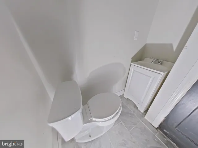 a white toilet sitting next to a sink