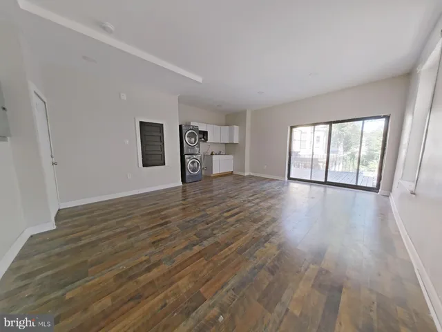 a view of a bedroom with wooden floor