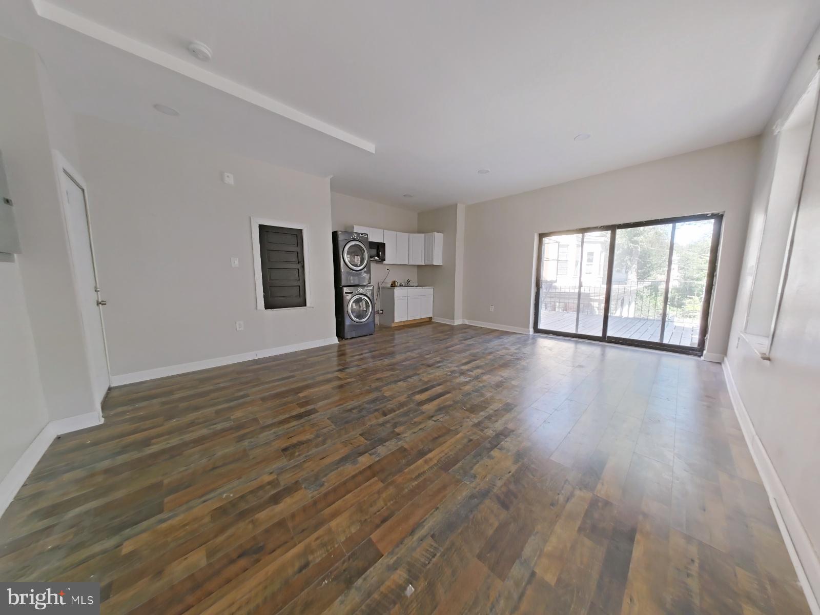 5331 Wayne Avenue Philadelphia, PA 19144 - Photo 27 of 53 a view of an empty room with wooden floor and a window