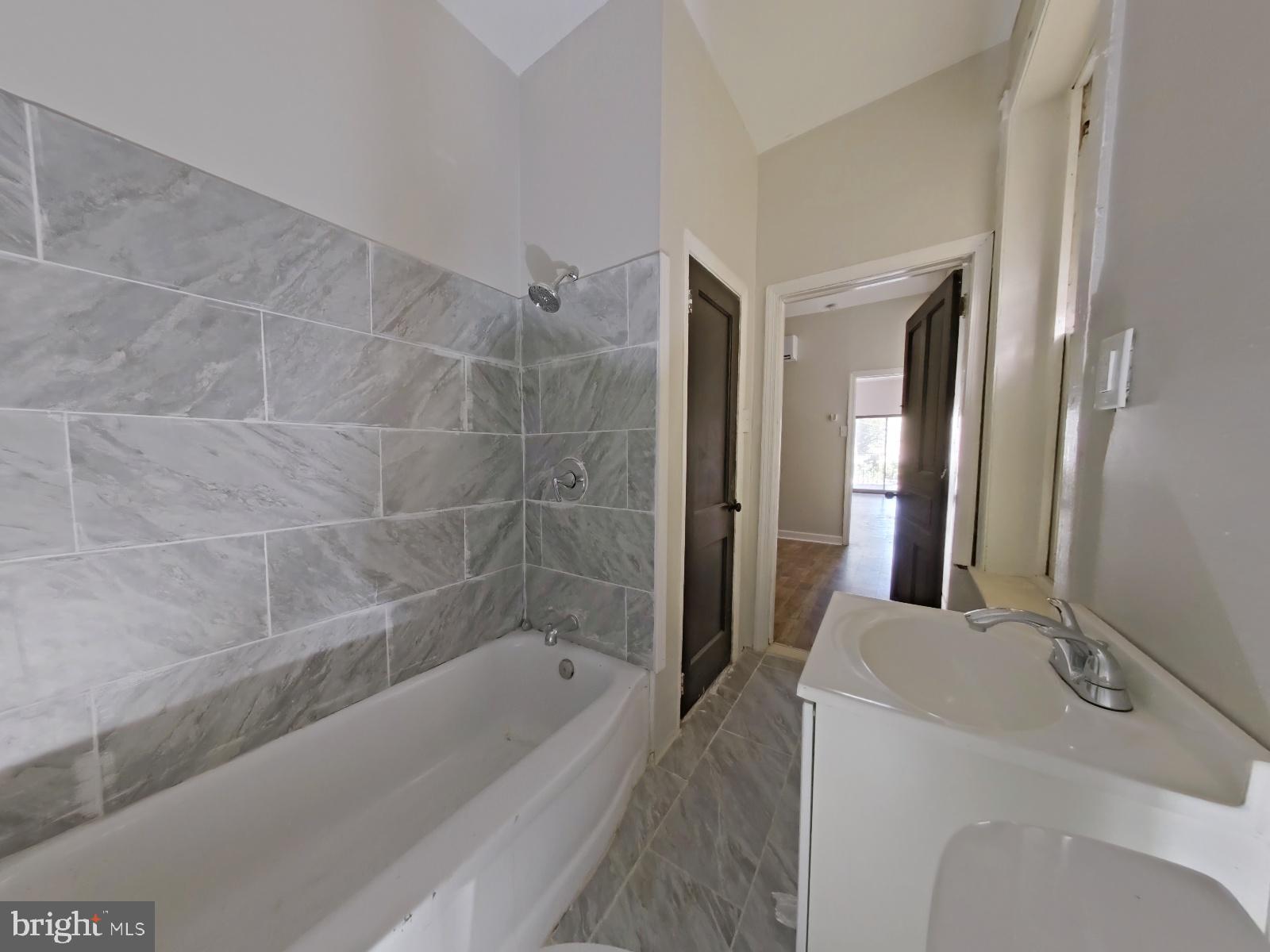 5331 Wayne Avenue Philadelphia, PA 19144 - Photo 32 of 53 a bathroom with a bathtub a mirror a sink and vanity