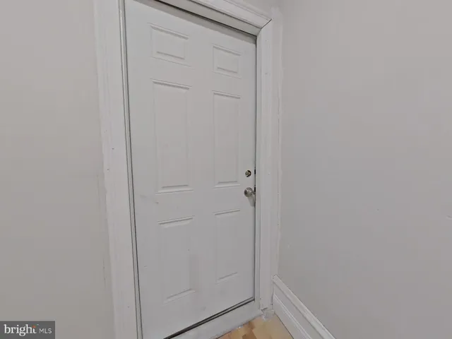 a view of a livingroom with wooden floor and a fireplace