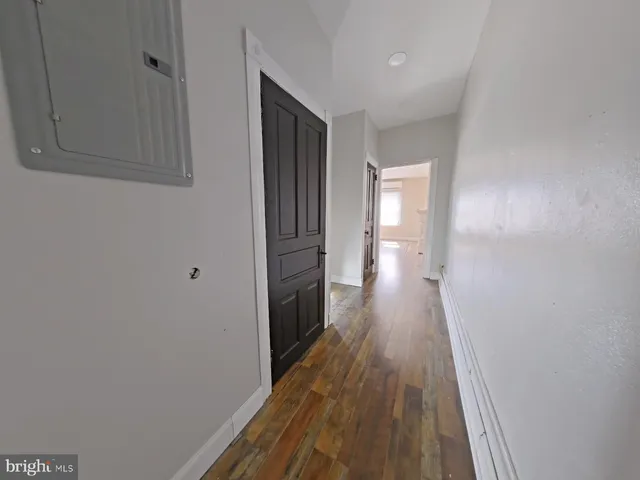 a view of a kitchen with fridge and window