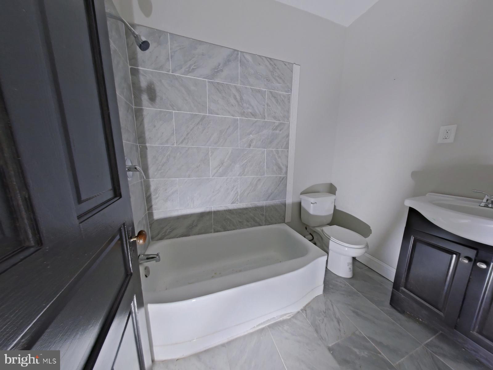 5331 Wayne Avenue Philadelphia, PA 19144 - Photo 50 of 53 a white bath tub sitting next to a toilet