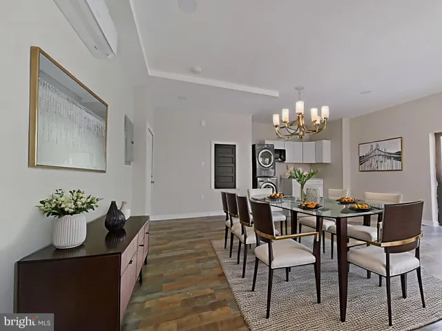 a dining room with furniture a chandelier and wooden floor