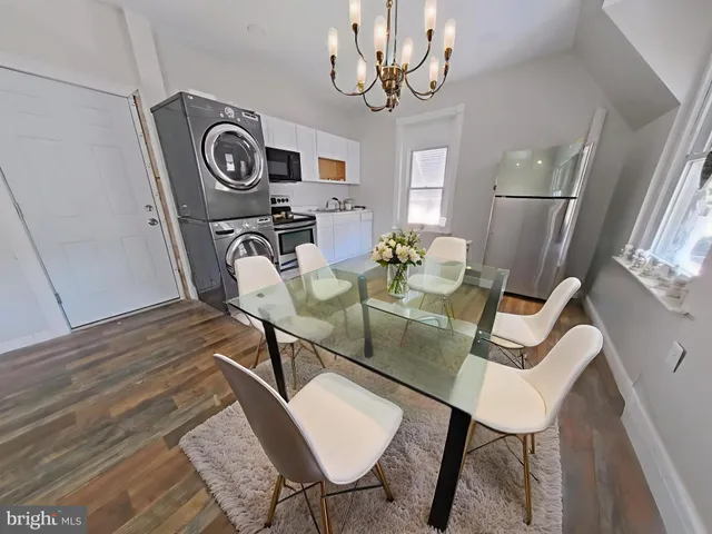 a view of a dining room with furniture wooden floor and chandelier