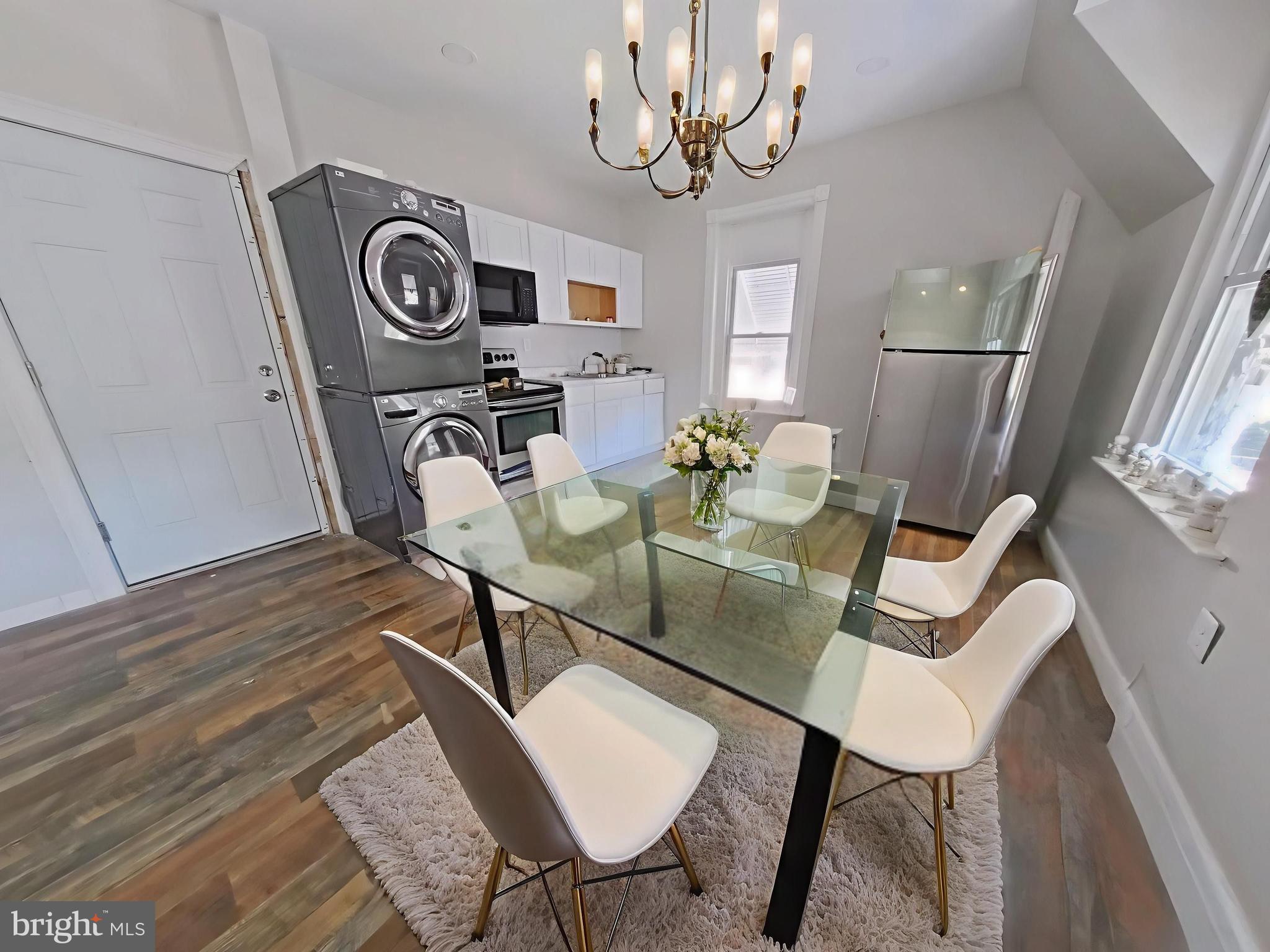 5331 Wayne Avenue Philadelphia, PA 19144 - Photo 7 of 53 a view of a dining room with furniture wooden floor and chandelier