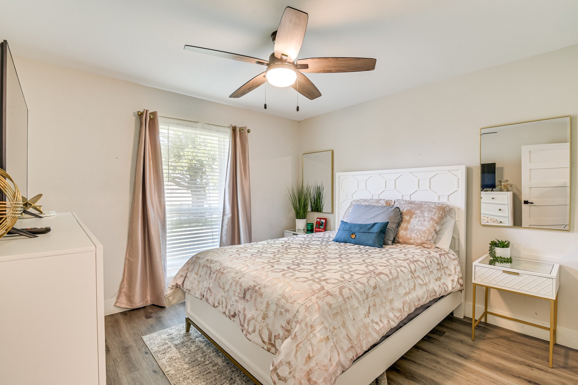 7003 McCoy Road Manvel, TX 77578 - Photo 16 of 27 a bedroom with a large bed and a chandelier