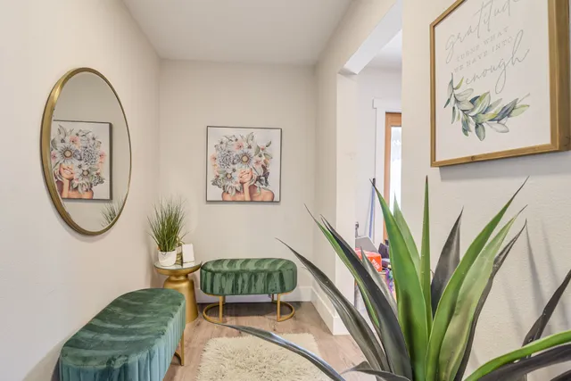 a view of a hallway with paintings on the wall