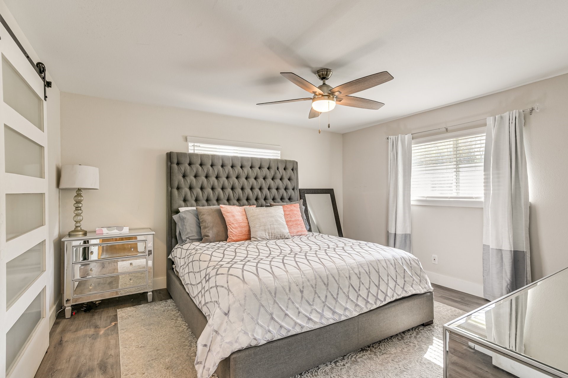 7003 McCoy Road Manvel, TX 77578 - Photo 8 of 27 a bedroom with a large bed and a chandelier