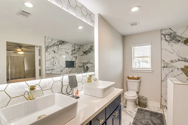 a bathroom with a granite countertop sink and a mirror